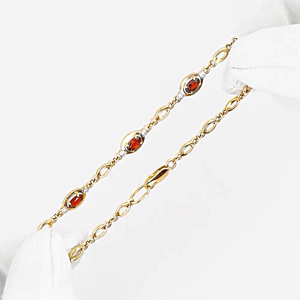 Браслет с гранатами и фианитами из красного золота 585 пробы